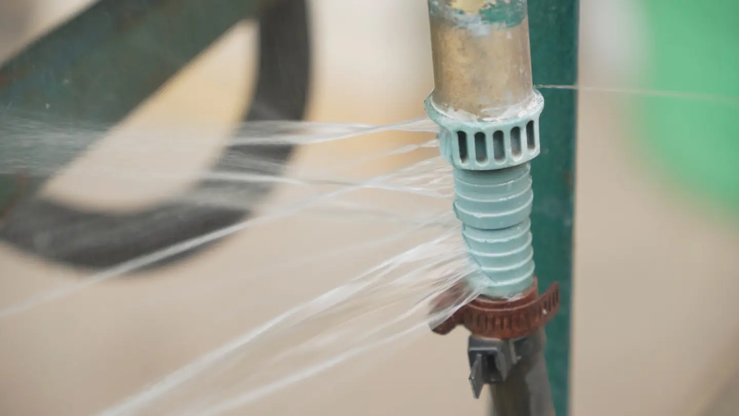 Water spraying from a split fitting on a supply line